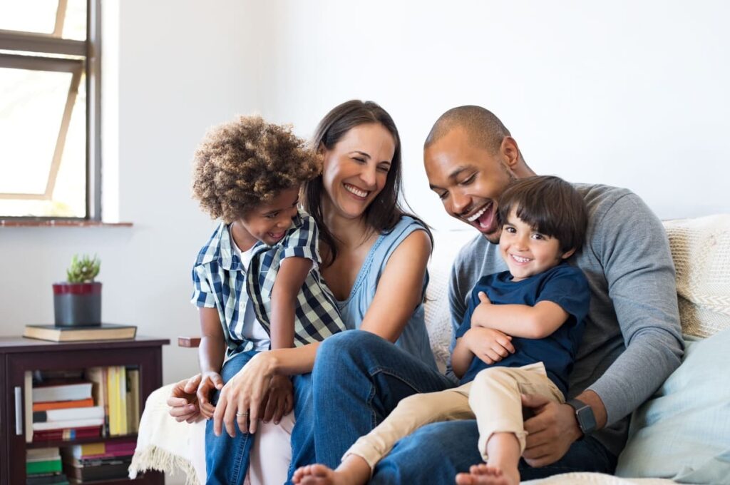 Mixed Race Young Family In City Home