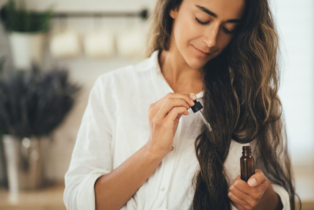 Woman Applying Hair Healing Serum